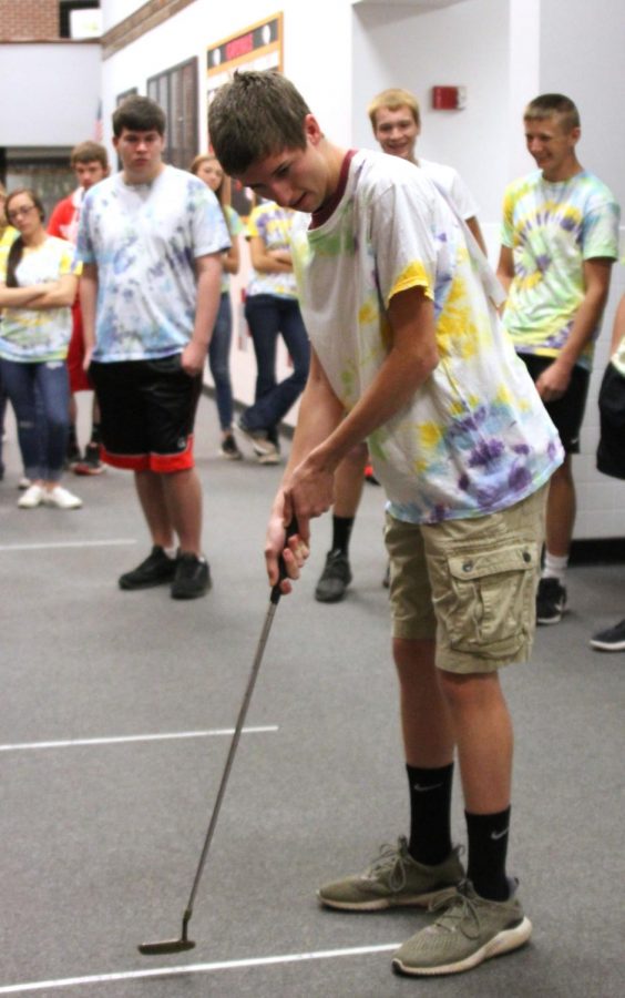 On Mole Day, senior Brenden competes for the Moleja Boys in a golf competition.