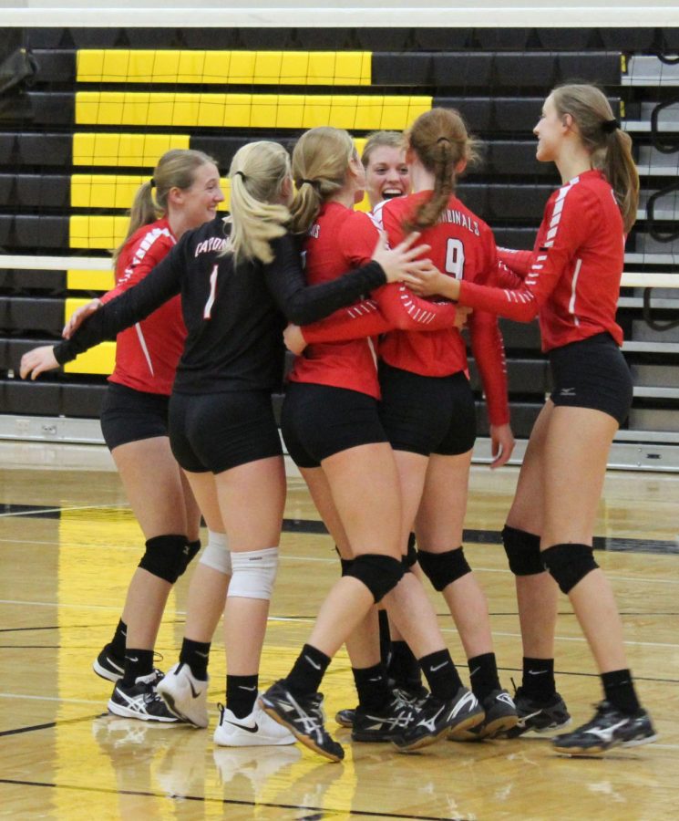 The team celebrates a point by gathering together in the middle of the court. 
“I felt like we did well despite losing, but we could have talked more. If we had we might have done better” Senior Kayla Koester said. 