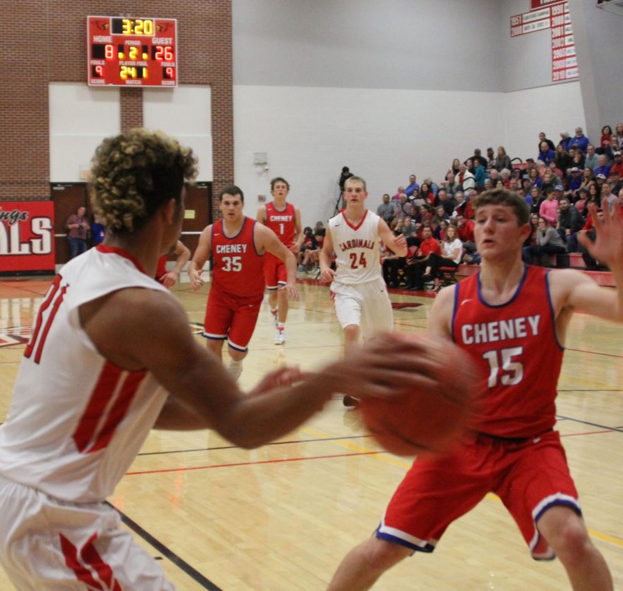 Sophomore Jonathan Wright passes the ball across the baseline during the Cheney game. The boys fought hard but lost 55-33. 