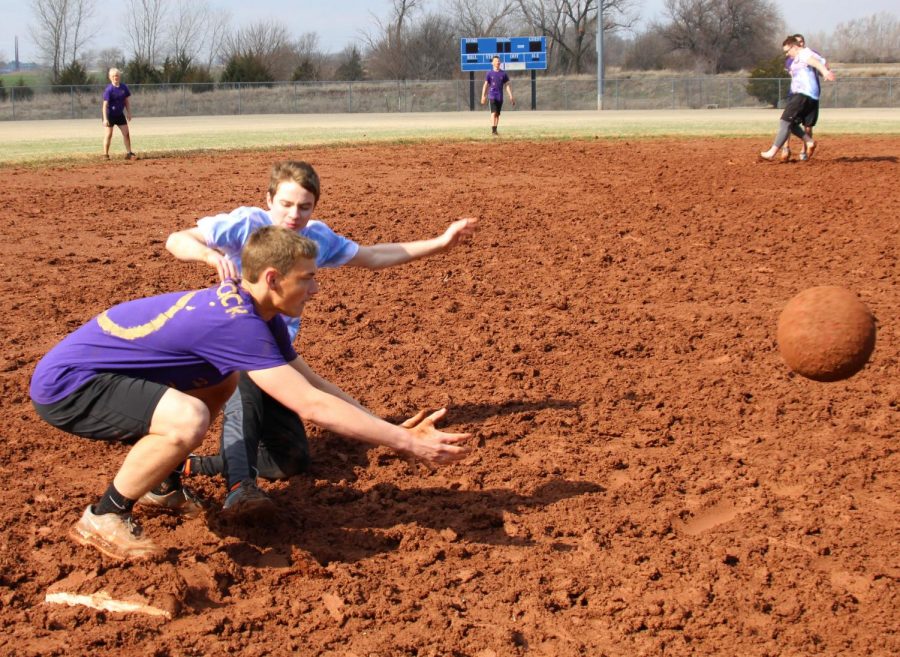 During kickball on March 23, junior Carson Clum slides into third base, making it safe, while junior Jack Ebenkamp waits for the ball. Carson's team was called Life’s a Pitch, and they took fifth overall. Photo by Lexi Fisher.
