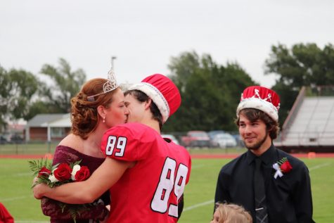 After being crowned queen and king, seniors Madison Pauly and Philip Ast share a kiss at the Fall Homecoming Ceremony. The ceremony was held on Oct. 4 at 6:30 p.m., followed by a victorious varsity game with a score 64-8.
