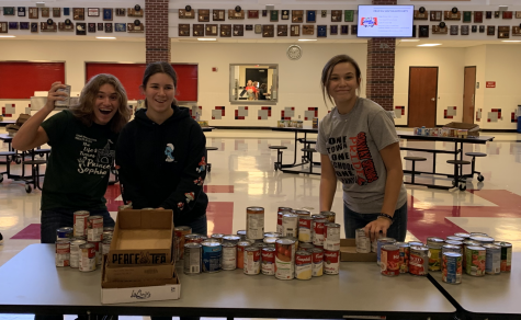 During the Cardinal Care Food Drive, junior Owen Balman and sophomores Averie Stull and Abby Botkin help separate the cans into boxes. Student Council volunteered to co-host the food drive to help donate to families in need. 
