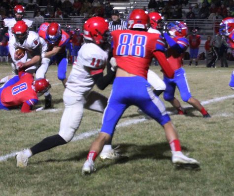 While playing against Eureka, junior Cole Schulte blocks a Tornado. The Cardinals won the game 40-7.