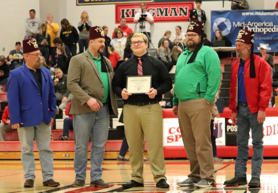 Senior Dawson Martin receives his Shrine Bowl certificate during halftime at the basketball game vs. Garden Plain Jan. 17. Martin will play in the Shrine Bowl on July 18 at Yager Stadium in Topeka. 