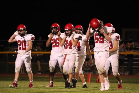 Photo by Cassidy Beal. Football players walk off the field Sept. 4 at Garden Plain High School. Since losing by 1 that day to the Owls, the team has won seven in a row, outscoring their opponents 376-76.