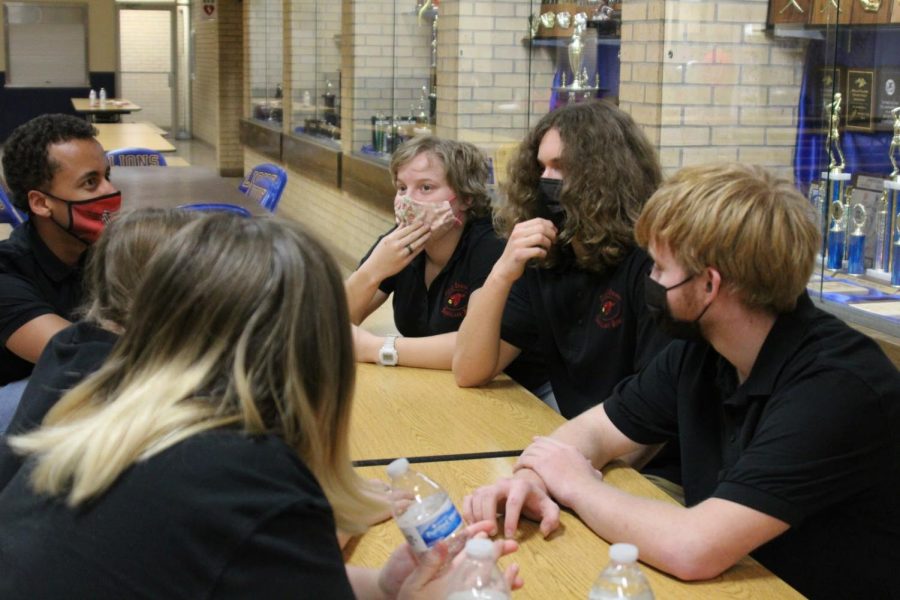 Before the meet, the varsity Scholars Bowl team members converse about possible questions in the rounds. This took place Feb. 4 for the regional Scholars Bowl meet at Bluestem.
	
