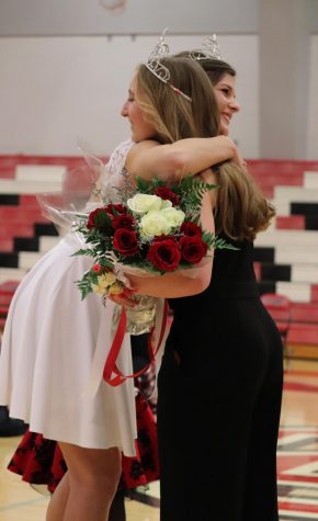 During the ceremony, senior Lucy Boyles hugs former queen Kylie Ast. While the crowd congratulated all of the candidates. “When I was walking down I felt calm and collected, but once they called my name I was surprised as heck,” Boyles said.