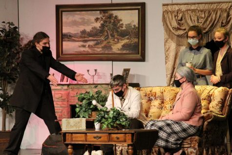 In the last act of “The Boardinghouse,” the characters huddle in the living room as they await an answer to the mystery behind the plot. This was during the Friday night performance on March 26. 