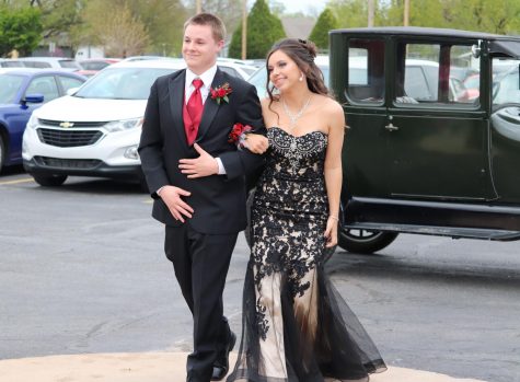 After arriving in his Model T Ford, senior Jacob Stuhlsatz walks up to the high school with junior Ally Lange for prom preview. Prom and After Prom took place April 17 and lasted from 6 p.m. to 2:30 a.m.
