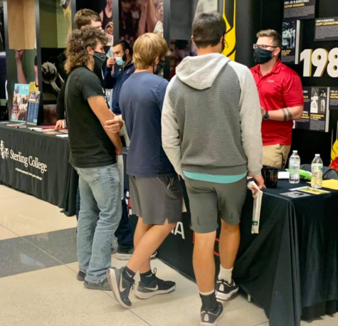 Seniors Lance Pauly, Logan Warren, and Derrick Smith and junior Zane Zoglmann talk to a representative. The Futures Fair was held at WSU on Oct. 12.
