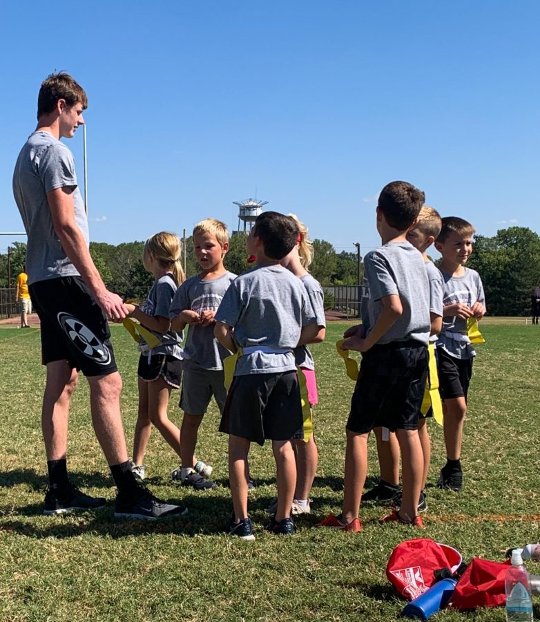 Senior+flag+football+coach+Lance+Pauly+gives+his+team+a+talk.+Pauly+coached+the+second+graders%2C+and+their+team+name+was+The+Sharks.