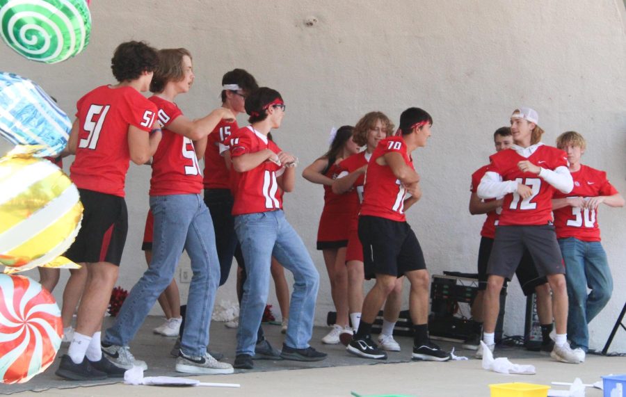 During the Homecoming pep rally, the football boys show off their dance moves with the cheerleaders. This is something new the cheerleaders incorporated into the pep rally. 