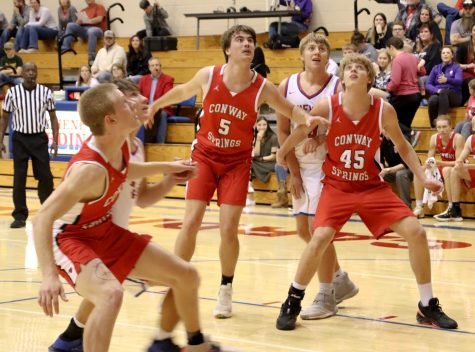 Sophomore Nash Johnsen and seniors Izic Billups and Patrick Friess play defense against the opposing team. The final score of the game was 41-68.