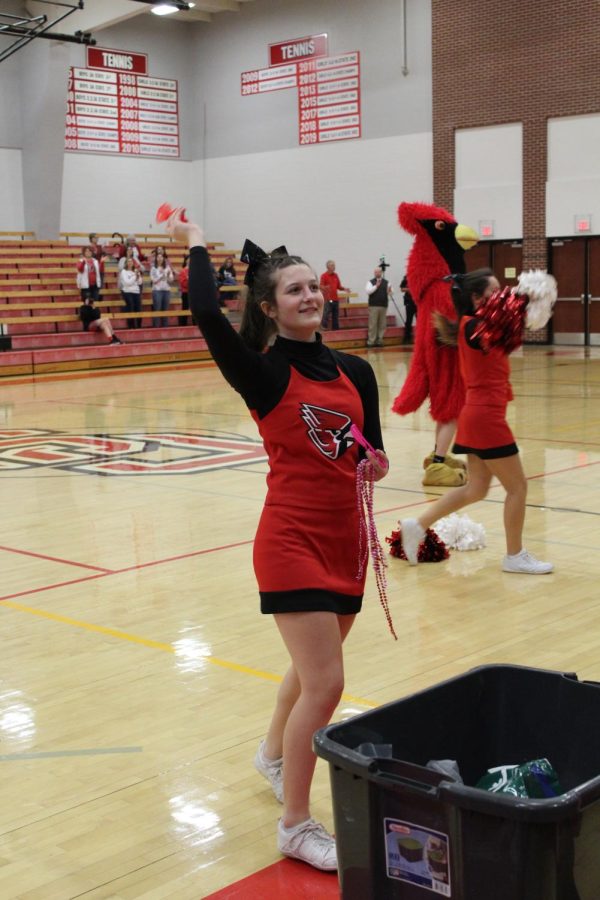 At the pep rally on Feb. 12. junior Hannah Zoglmann throws treats into the crowd. Zoglmann will be a returning to cheer team in 2022-23.