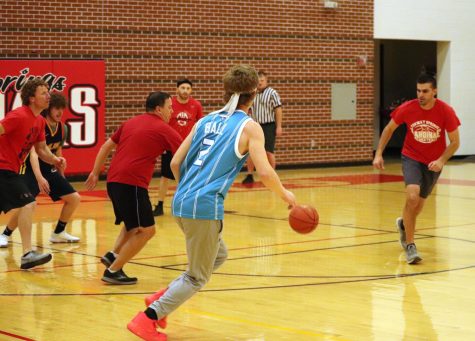 Senior Izic Billups dribbles around the teachers during the games. The Senior Faculty games were held on Tuesday last week.