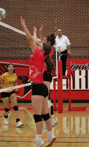 In their match against Belle Plaine, sophomore Regan May and junior Kaley Perkins go up for a block. The Cardinals lost the match against Belle Plaine.
