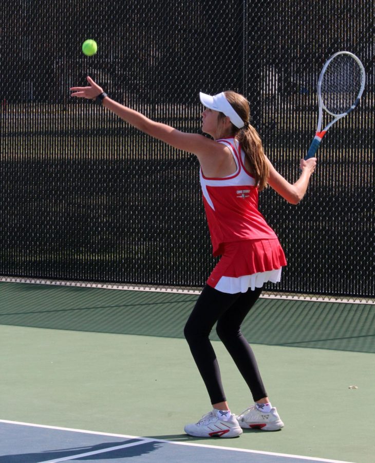 Freshman Sadie Koester gets ready to serve the ball. She and doubles partner Grace Bender qualified for State in Topeka.