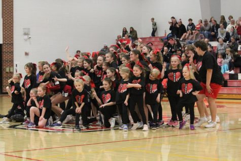 The cheerleaders pose with the kids at the end of the dance during the girls varsity game Feb. 10. The cheer clinic danced to “Sugar” by Maroon 5. 
