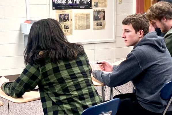 Senior Caitlyn May and junior Alex Hekel talk in between rounds at Regionals in Inman Feb. 2. 