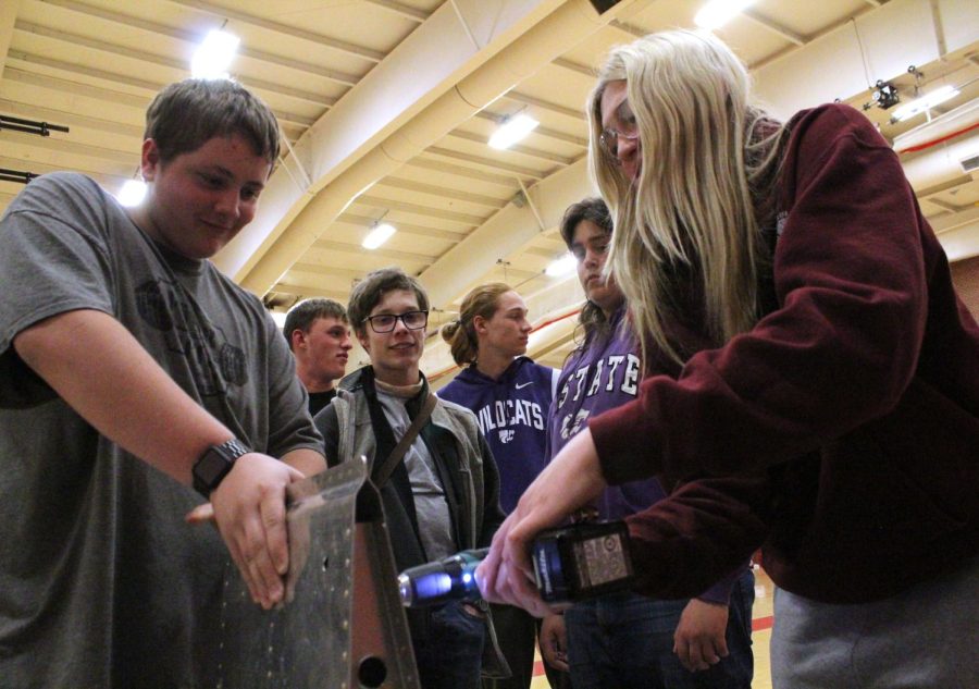 During the K-State Polytechnic Roadshow, juniors Jacob Osner and Faith Kelly practice riveting at the aerospace engineering station. This station also showed the tips of an airplane wing. 
