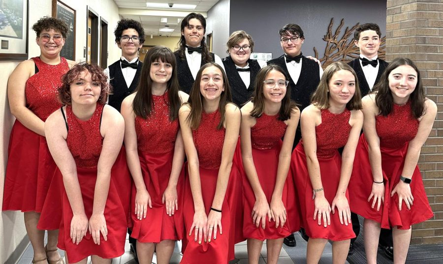 The Cardinalaires pose for a photo at the beginning of regionals at Butler Community College. The song they sang was “Come to the Music.”