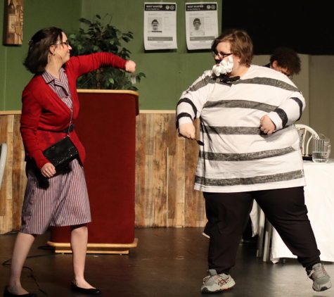 Senior Caitlyn May as Cecelia Bluebood and sophomore James Hancock as Beans engage in a swordfight consisting of a table fork and a soup spoon. The performances of “Million Dollar Meatballs” were held on March 31 and April 1. 