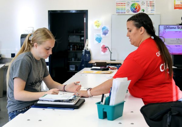 Art teacher Jennifer Potts helps senior Makenna Wylie with a zentangle project in her classroom during Art II. Students in the class were working on developing their knowledge of the usage of lines in an artwork. 