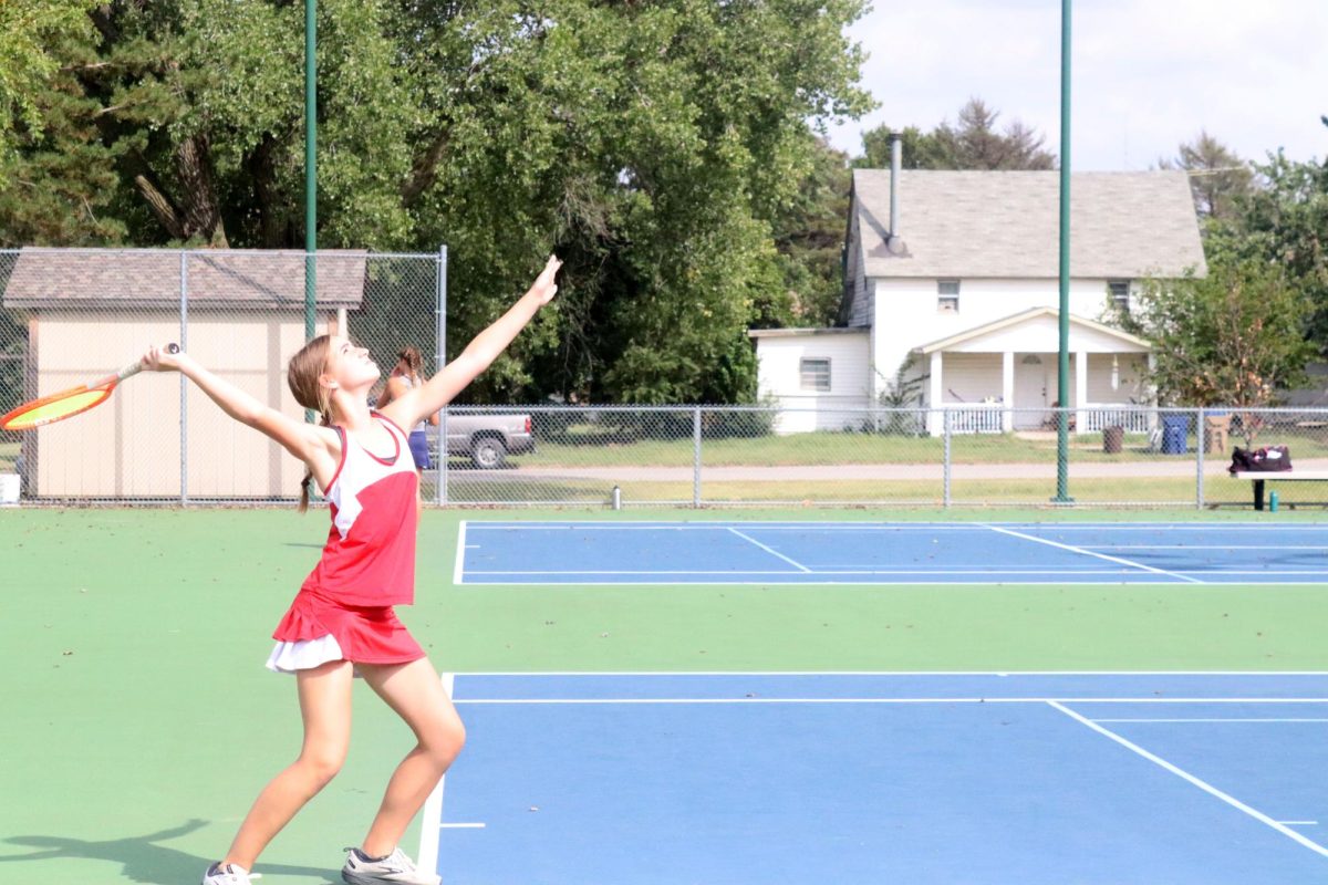 At+the+tennis+courts%2C+freshman+Addison+Rusco+starts+the+meet+off+with+a+serve.+The+meet+was+held+on+Sept.+12.+%0A+%0A