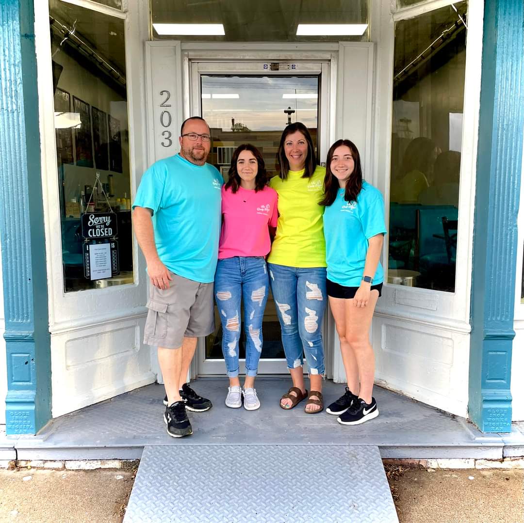 Just a few days before opening, Wade Kennard, Bailey Kennard, Daphne Kennard, and Melainy Kennard stand in front of the shop for a photo.