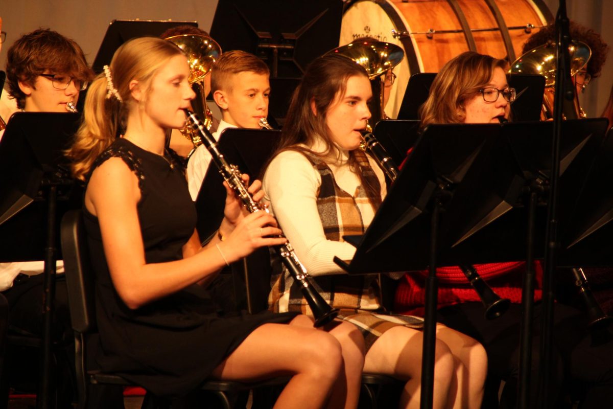 Freshman Joslin Bartelson and juniors Addie Pauly and Madison Mishler play the clarinet for the high school concert. The concert was held Dec. 11 in the high school auditorium.
