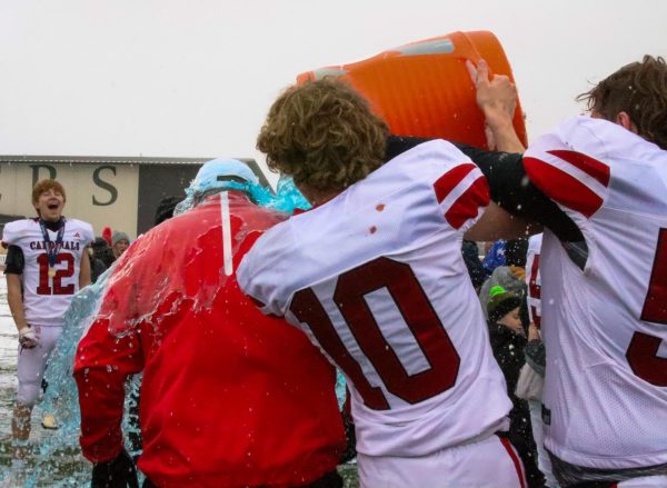 Senior Jacob Osner and sophomore Logan Osner pour Gatorade on head coach Matt Biehler per tradition after winning State Nov. 25. The State game was held at Fort Hays University, and the Cardinals triumphed over the Jefferson County North Chargers 35-6.
