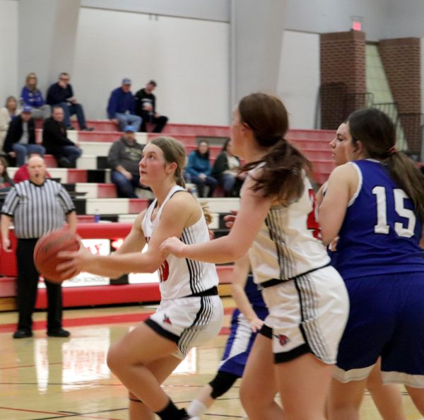 Sophomore Morgan Koester goes in for a layup as junior Raylee Chitwood blocks a Caldwell opponent. The girls finished the game Dec. 12 with a score of 60-17.
