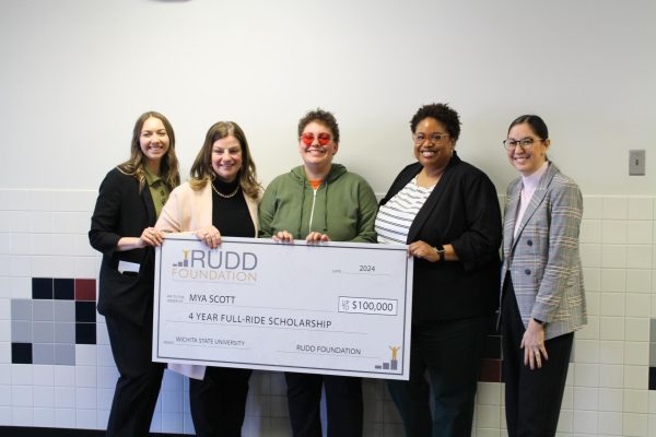 Senior Mya Scott accepts a giant check from the Rudd Scholarship team. Scott plans on majoring in journalism and media productions. 

