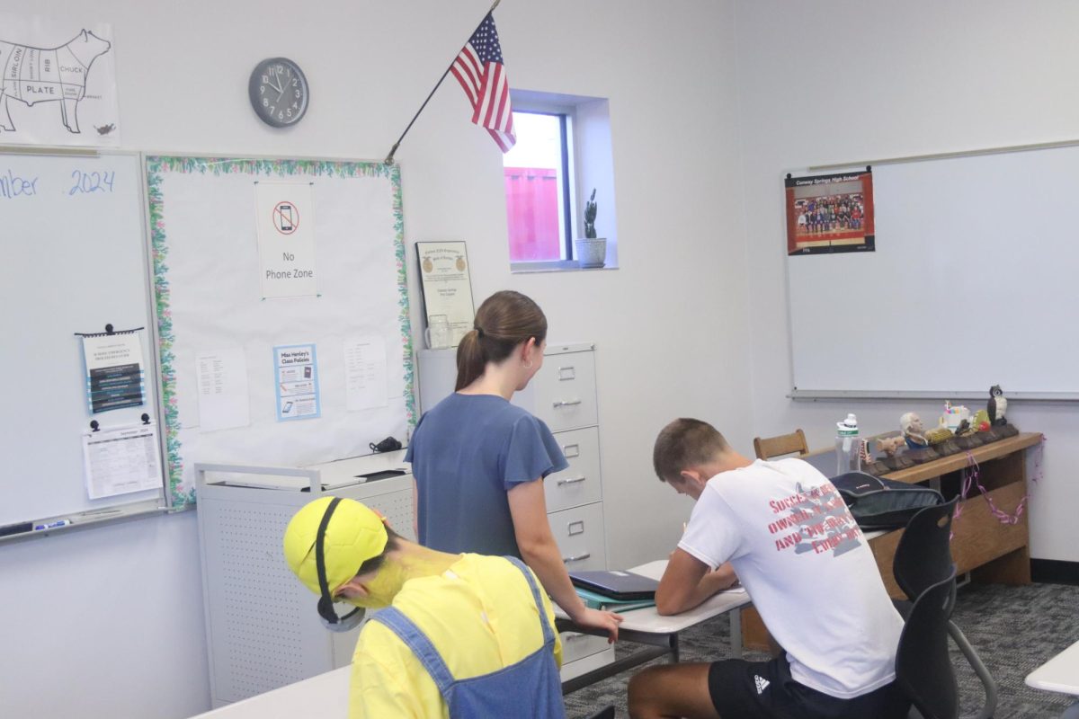 Ag teacher Shelby Henley helps junior Colton Friess and junior Isaiah Rivera.
The students needed help with a worksheet while in their AP class.
