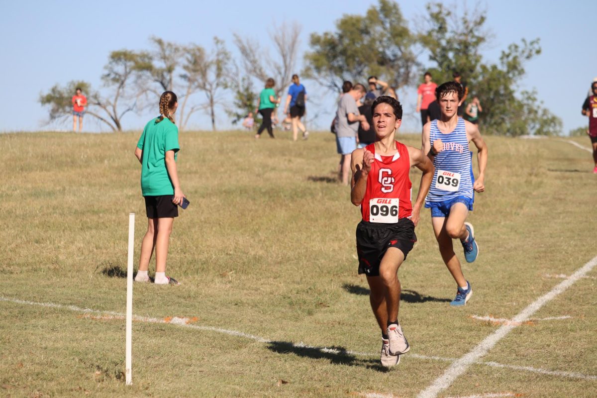 At the Lake Afton cross country meet, junior Isaiah Rivera races towards the finish line. Rivera finished this race with a time of 21:33.72.