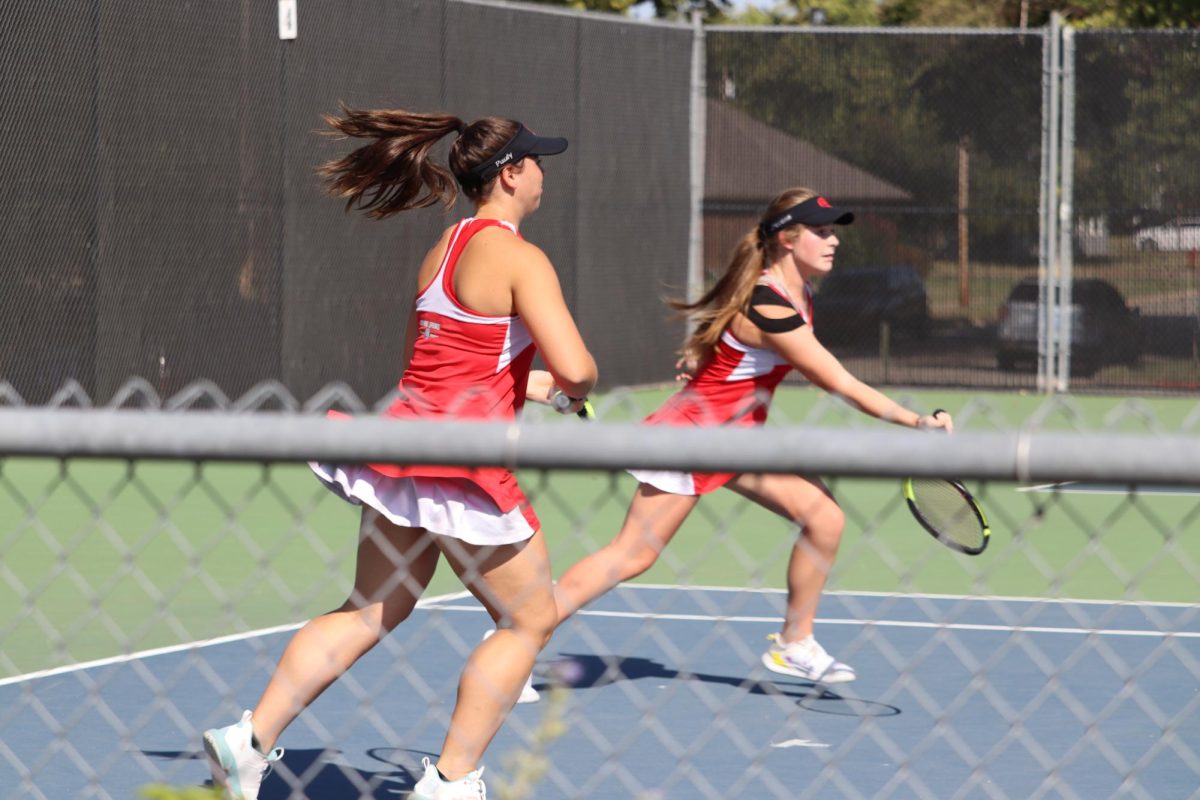 Juniors Maddy Stevens and Hayley Pauly attempt to score a goal during one of their tennis matches.