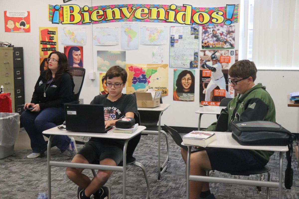 In spanish class, Mrs. Hardy and students listen to a presentation while working on their day of the dead project. Stude