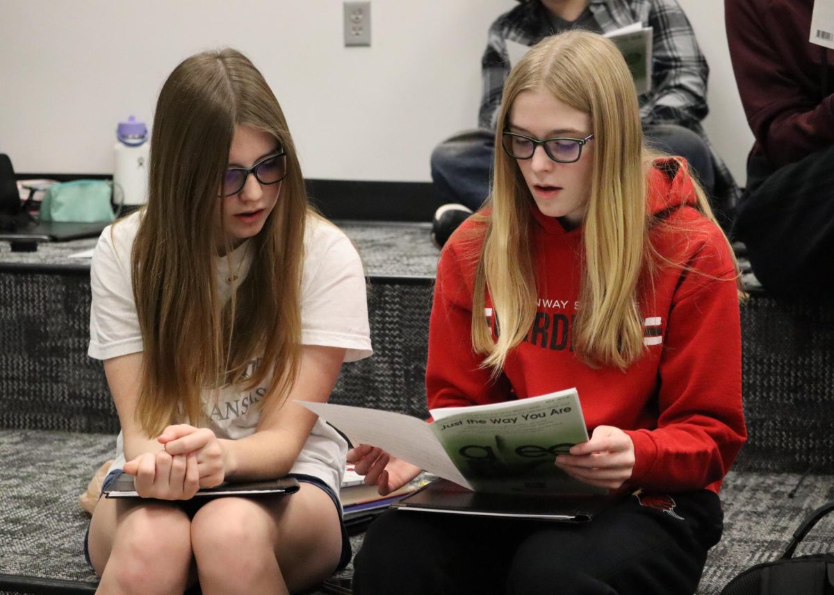 Freshmen Jenny Murphy and Jade Erker practice a song for Cardinalaires. The song was performed for singing telegrams. 