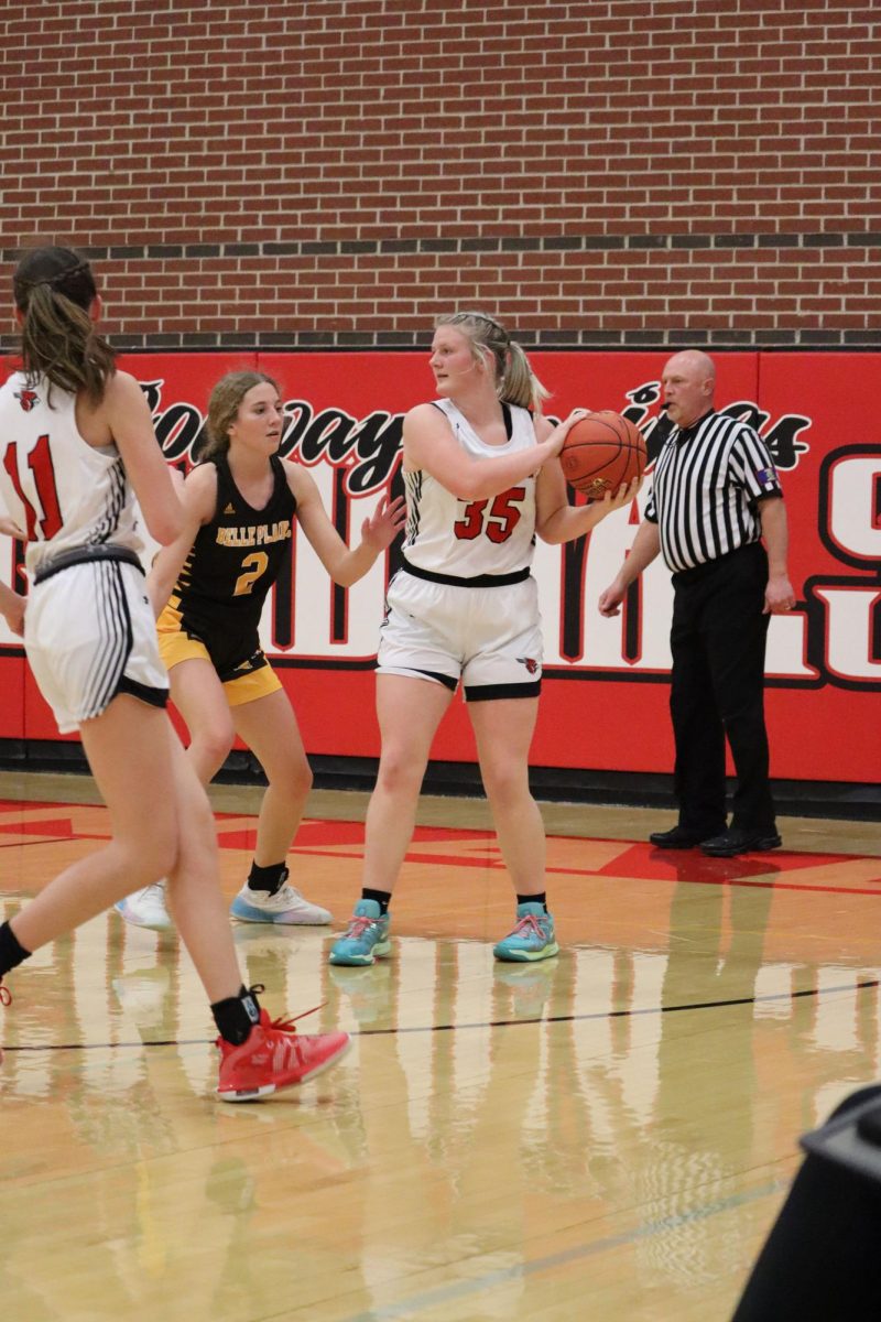 While playing in a home basketball game junior Macie Hartman searches for a teammate to pass the ball to. Hartman is the teams leading rebounder averaging 7.5 rebounds per game.