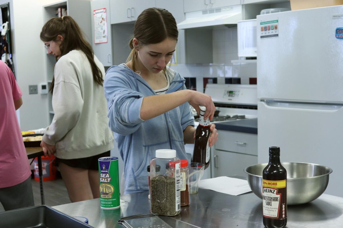 While making a seasoned barbecue sauce sophomore Adysen Rusco looks over the recipe. This sauce was for a recipe being used on the day of the MSCPL music contest which was held at CSHS.
