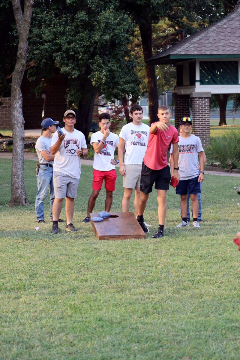 A group of high school boys play cornhole at the park during the Back to School Bash. Stuco provided this and many more games.
