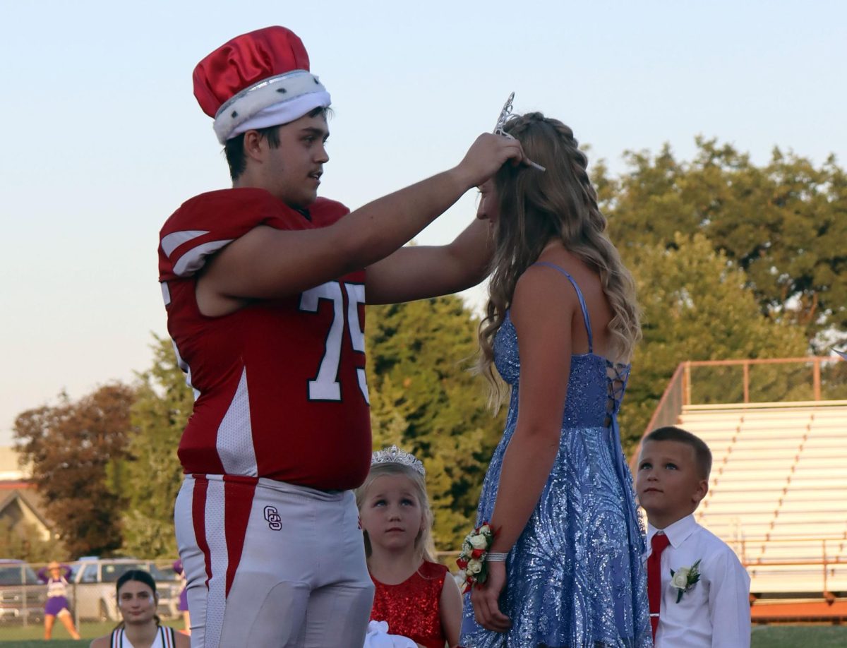At the Fall Homecoming ceremony, senior Konner Bidwell places the crown on senior Morgan Koester's head. The after party took place after the football game.