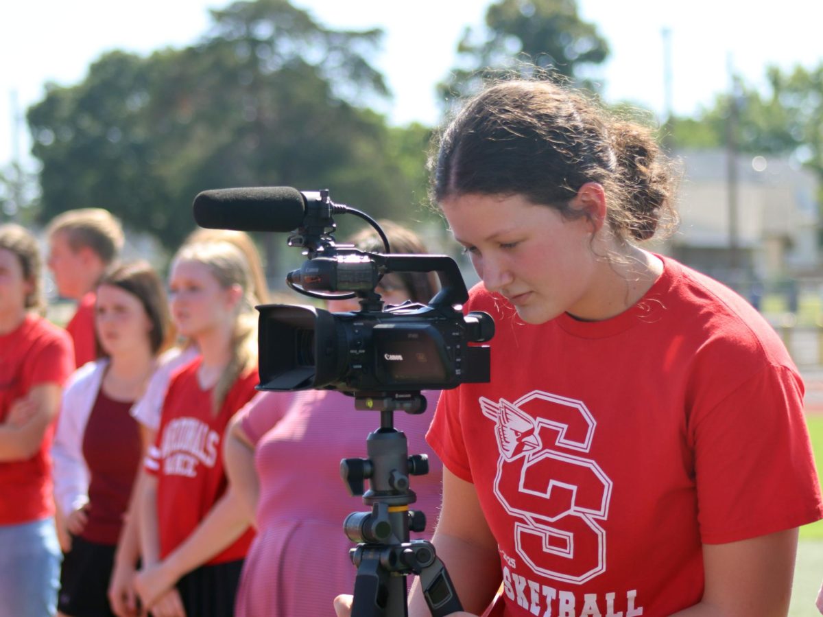 While students participated in the Battle of the Classes games, sophomore Bri King catches some seniors in action for the senior video. 