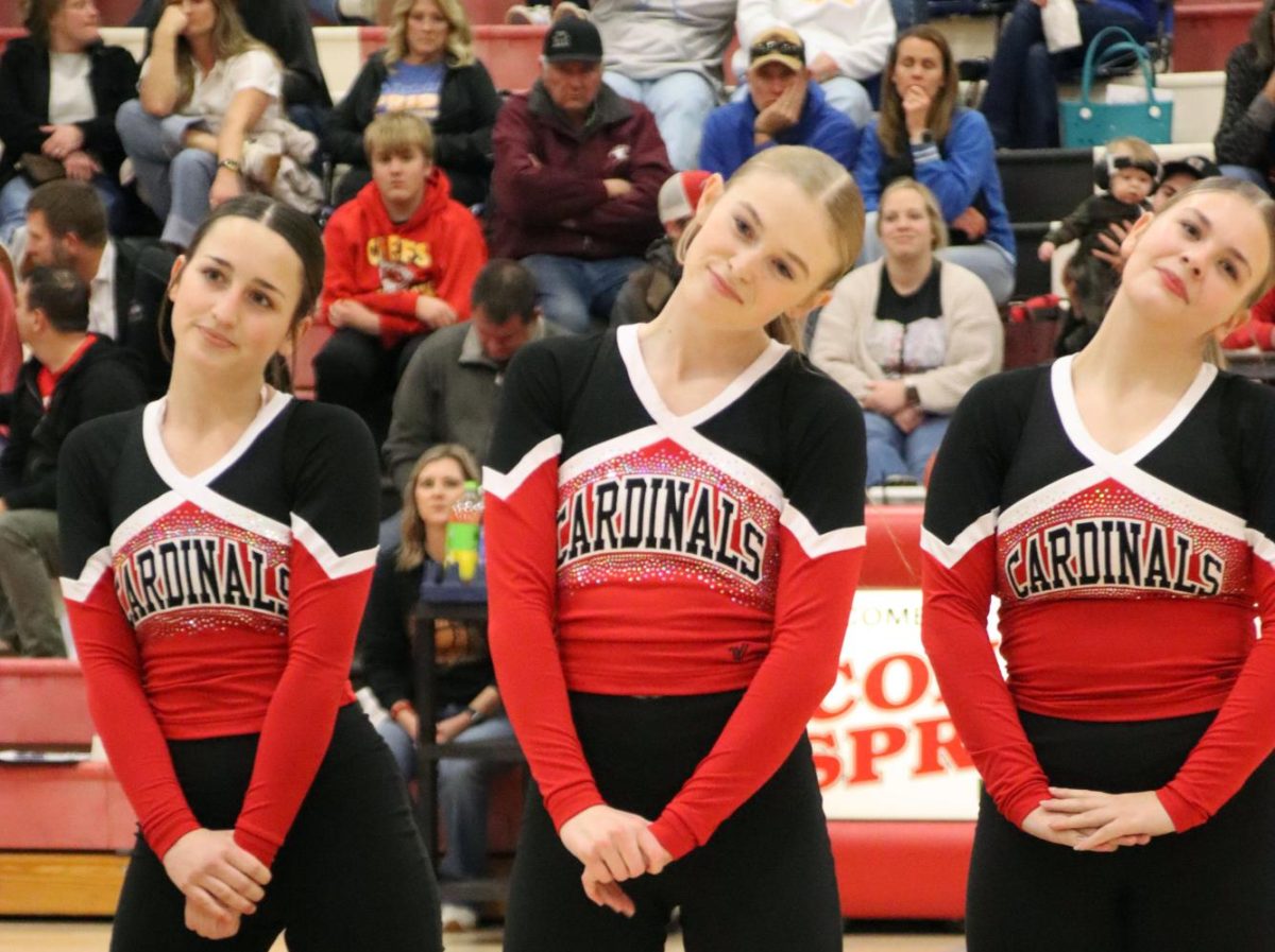 At the basketball game, junior Adysen Conkle, sophomore Jade Erker, and freshman Josie Ebenkamp are posing at the end of their halftime dance. 