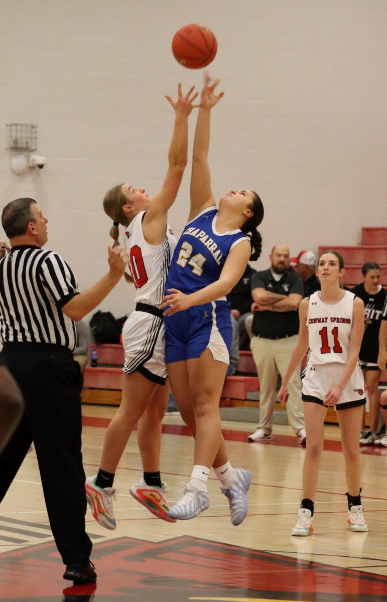 At the home basketball game against Chaparral, senior Morgan Koester jumps for the ball. Koester is part of the starting varsity team.